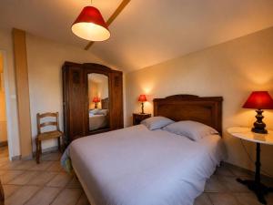 a bedroom with a large white bed and a chair at Maison 2 chambres avec jardin clos en Sologne, animaux acceptés - FR-1-489-258 in Aurouer