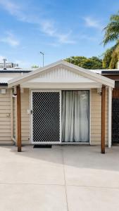 a house with a garage with a gate at Private Guest Studio House, Separate Entry in Brisbane