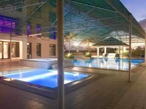 a large swimming pool with a building in the background at Monte Carlo Lounge Two in Manila