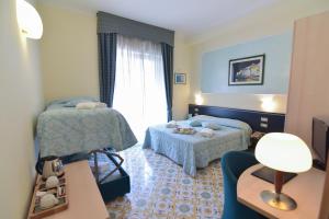 a hotel room with two beds and a window at Hotel Santa Lucia in Minori +146 photos