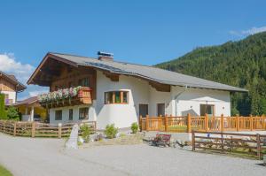 a small house with a fence in front of it at Pension Zeitlos in Wagrain