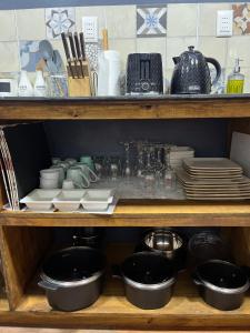 a wooden shelf with plates and dishes on it at Domo ancud glamping in Lechagua