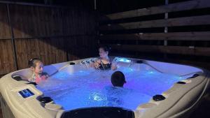 two children are in a jacuzzi tub at Black Stone Family Garden Villa in Yaoqiaoyu