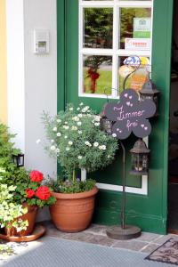 a store front with flowers and a sign on the door at Hotel-Pension Wagnermigl in Kuchl