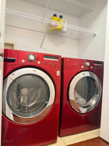 two red washing machines sitting next to each other at Private MasterBedroom in Charlottetown