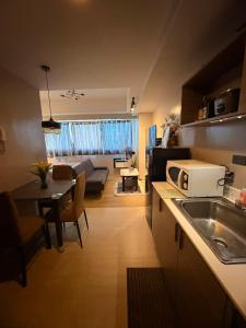 a kitchen and living room with a couch and a table at Monte Carlo Lounge Two in Manila