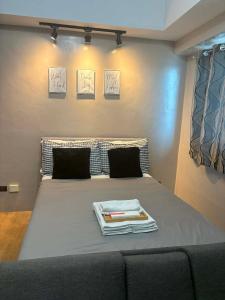 a bedroom with a bed with a gray bedspread at Monte Carlo Lounge Two in Manila