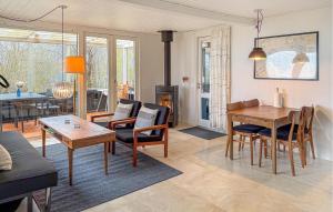 a living room with a table and a dining room at Gorgeous Home In Rødekro With Wifi in Rødekro