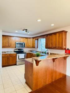 a kitchen with wooden cabinets and a counter top at Private MasterBedroom in Charlottetown