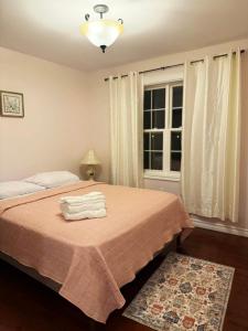 a bedroom with a bed with two towels on it at Private MasterBedroom in Charlottetown