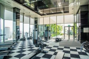 a gym with a checkered floor and large windows at BTS Thong Lor Central High -rise Condo in Bangkok