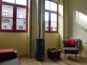 a living room filled with furniture next to a window at Canvas Atelier Hostel in Porto