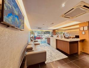 a living room with a couch and a bar at Alaxis Hotel in Kuala Lumpur