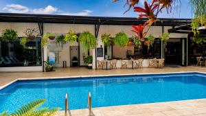 a swimming pool in front of a building with a restaurant at KC Hotel San Jose in San José +36 photos