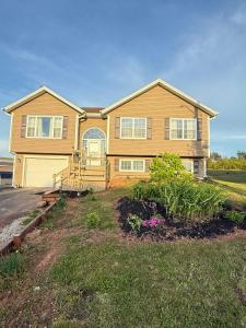 a large house with a porch and a yard at Private MasterBedroom in Charlottetown