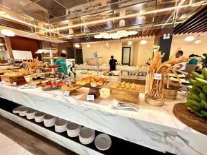 a buffet line with food on display in a restaurant at Mona Luxe Apartment Hoi An in Hà My Tây (2)