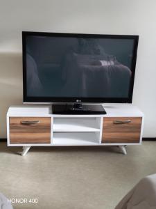 a flat screen tv on a white entertainment center at Light Home in Sodankylä