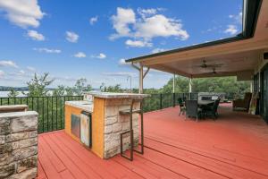 a deck with a grill and a table and chairs at Mountain Trail Retreat in Austin