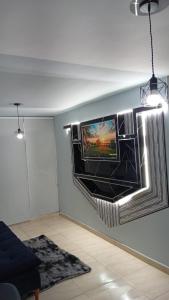 a tv hanging on a wall in a living room at Bello apto en armenia 1306 in Armenia