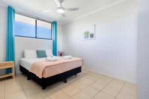 a bedroom with a bed and a window at Sea Air 24 in Yeppoon