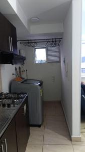 a kitchen with a sink and a stove in it at Bello apto en armenia 1306 in Armenia