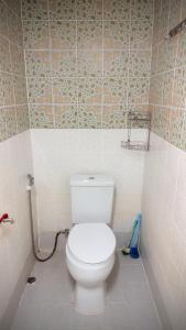 a bathroom with a white toilet in a room at Traditional Thai House Chaloklum in Chaloklum +21 photos