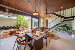 an open living room with a table and chairs at Nala Villa - Peaceful Hideaway with Pool & Yoga Space in Canggu