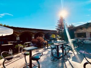 a group of tables and chairs on a patio at Hipodruma Resort & Pool in Dobrich