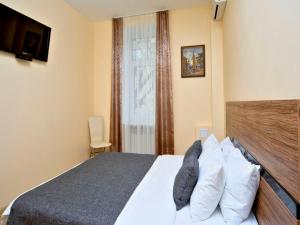 a bedroom with a bed and a window at Sunday Apart Hotel in Kyiv