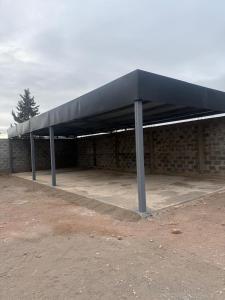 a black roof on top of a brick building at Acordes de Gaitas - Departamento 1 in Malargüe +4 photos