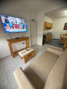 a living room with a large flat screen tv at Acordes de Gaitas - Departamento 1 in Malargüe