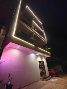 a building with lights on the side of it at night at PV Tower - Auro Beach in Kuilapayam