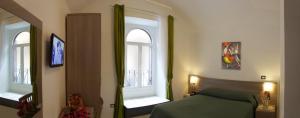 ローマにあるB&B Trastevere in Bedのベッドルーム1室(緑のベッド1台、窓2つ付)