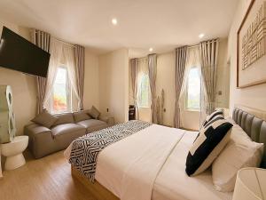 a bedroom with a large bed and a couch at The View Boutique Hotel in Vung Tau +55 photos