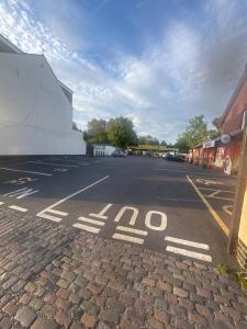 an empty parking lot with a stop sign on the street at The Navigation Inn Hotel in Derby
