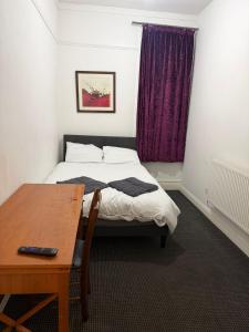 a bedroom with a bed and a table and a window at The Navigation Inn Hotel in Derby