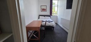 a bedroom with a bed and a desk and a table at The Navigation Inn Hotel in Derby