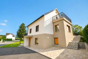a house with a balcony on top of it at Dovce Apartments in Rakek