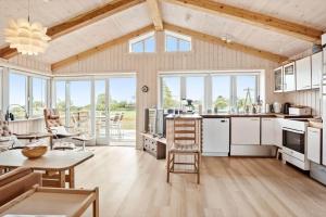 a kitchen and living room with a table and chairs at FY173-Asperup-Elmevaenget-8 in Asperup