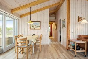 a dining room with a table and chairs and a couch at FY173-Asperup-Elmevaenget-8 in Asperup