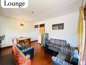 a living room with two couches and a table at Oracle Residence in Anuradhapura
