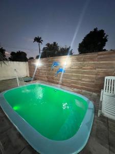a jacuzzi tub in a backyard at night at Casa com piscina in Belfort Roxo +22 photos
