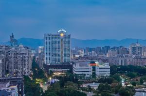 a city skyline with a tall skyscraper at Empark Grand Hotel Fuzhou in Fuzhou