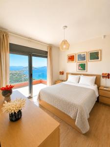 a bedroom with a bed and a large window at Villa Harmonia in Egina +51 photos