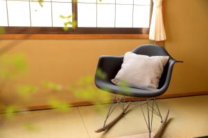 a black chair with a pillow in a room at Matsumoto BASE in Matsumoto +24 photos