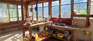 a kitchen with a bunch of windows and a sink at Mộc Tín Farmstay in Lạc Dương