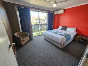 a hotel room with a bed and a window at Rockhampton Court Apartment in Rockhampton