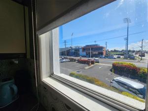 a window with a view of a parking lot at Rockhampton Court Apartment in Rockhampton
