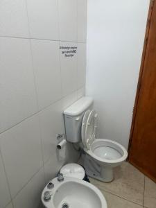 a bathroom with a toilet and a sink at Acordes de Gaitas - Departamento 2 in Malargüe +8 photos