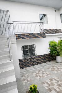 a white building with stairs and plants in a courtyard at Sol caribe aptos in Santiago